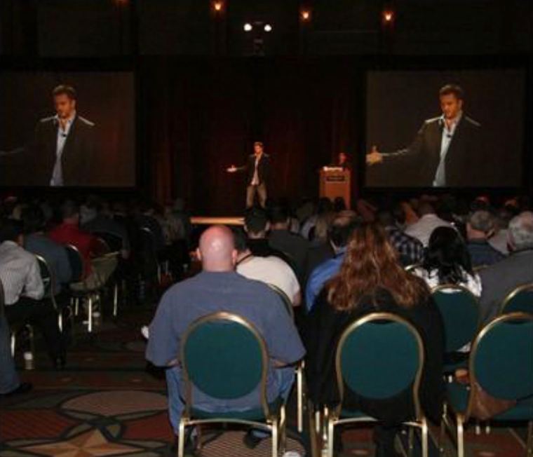 Jimmy Davis on stage in front of a packed room